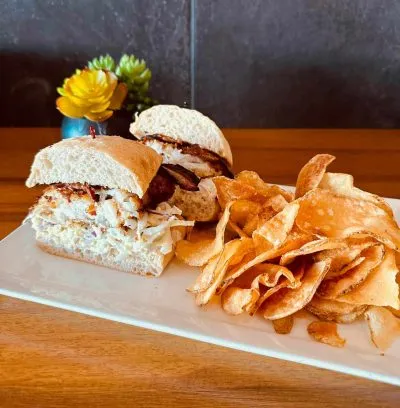 Grouper sandwich with ranch slaw and French fried potato slices at 5350 The Pourhouse