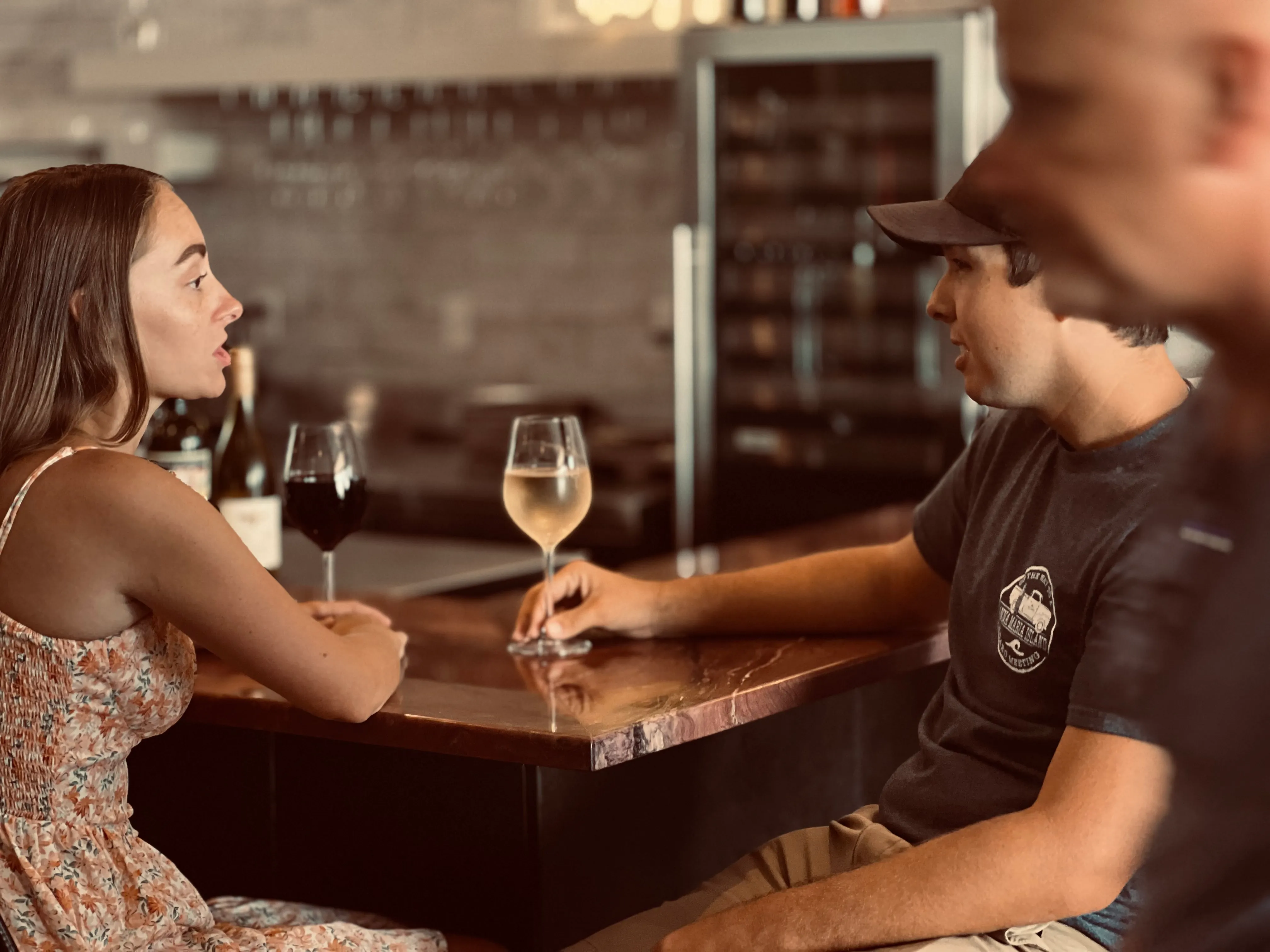 Couple with wine at a counter top bar